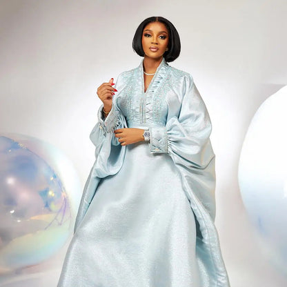 Sophisticated luxury dress featuring an elegant V-neck and intricate rhinestone embellishments, designed for women celebrating African heritage in style.