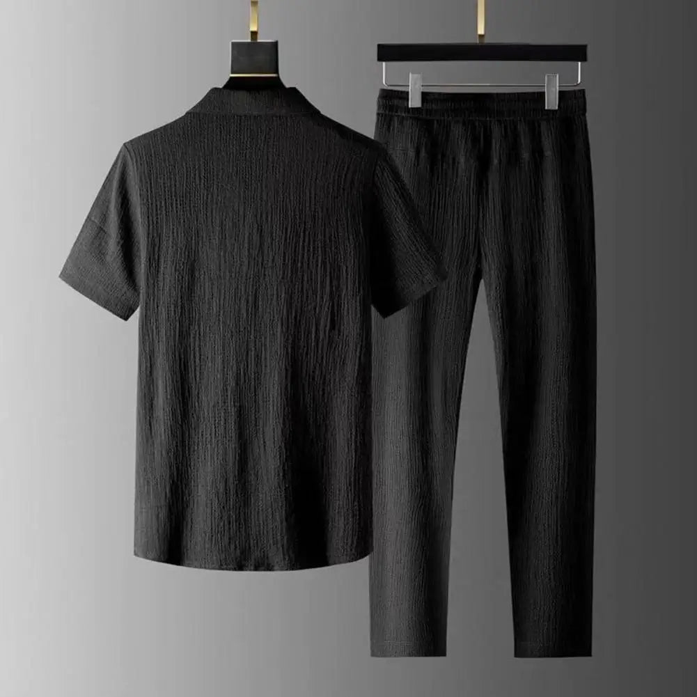 Complete view of the elegant men's casual summer suit laid out on a soft fabric background, highlighting the premium polyester material in a solid colour palette.