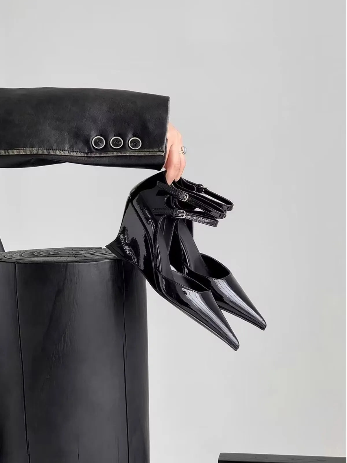 Stylish high heel wedge sandals for spring, featuring a pointed toe and a luxurious buckle closure, embodying modern sophistication.