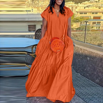 Sophisticated loose fit sundress, highlighted by its elegant silhouette and vibrant colour, perfect for warmer days and festive gatherings.