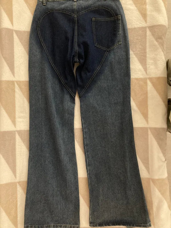 Chic view of CM.YAYA women's high street wide leg flare jeans showcasing intricate hollow cutout detailing, embodying contemporary fashion with a regular fit.