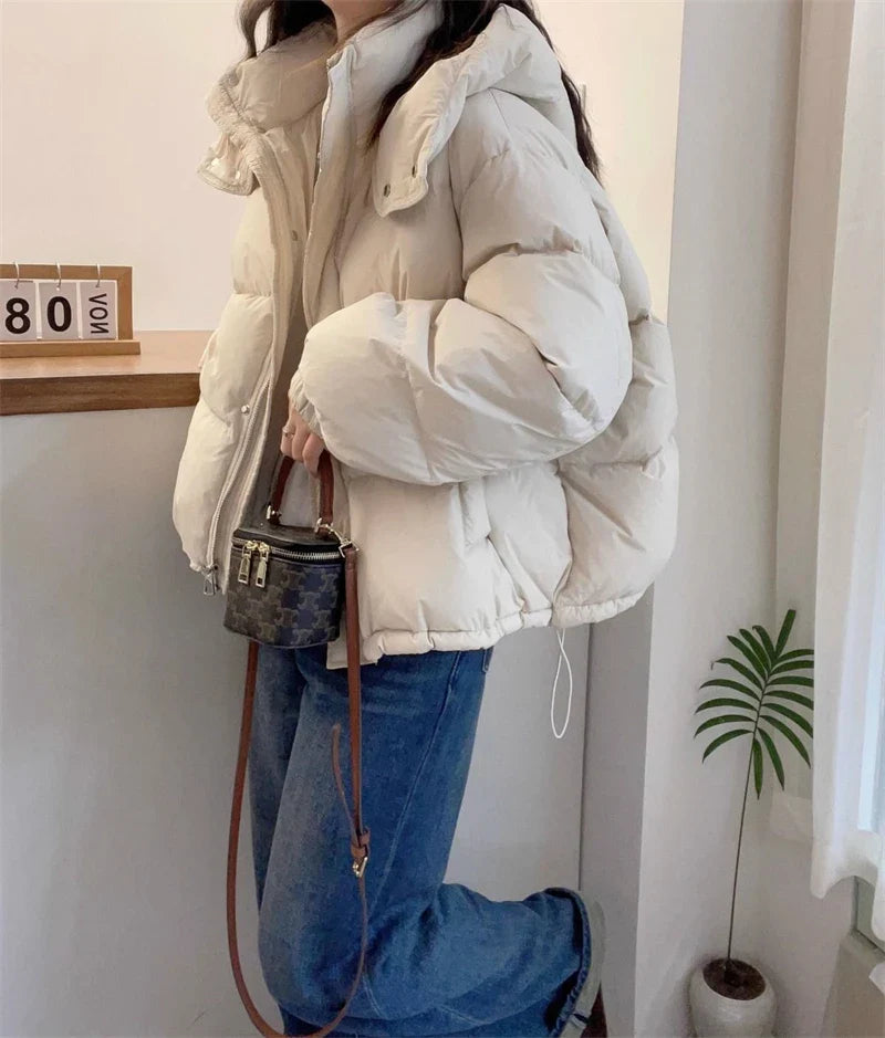 Sophisticated solid pattern women’s cotton puffer jacket, enhanced with practical pockets, ideal for a fashionable winter look.