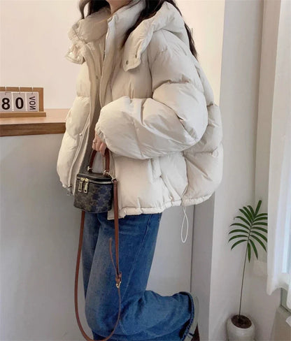 Sophisticated solid pattern women’s cotton puffer jacket, enhanced with practical pockets, ideal for a fashionable winter look.