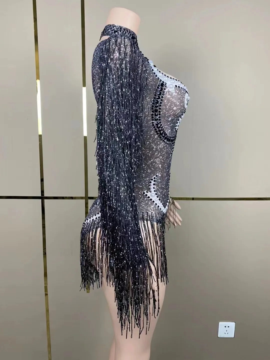 Detailed close-up of luxury women's cha-cha dance practice suit showcasing intricate pearl accents and a stylish fringe design.