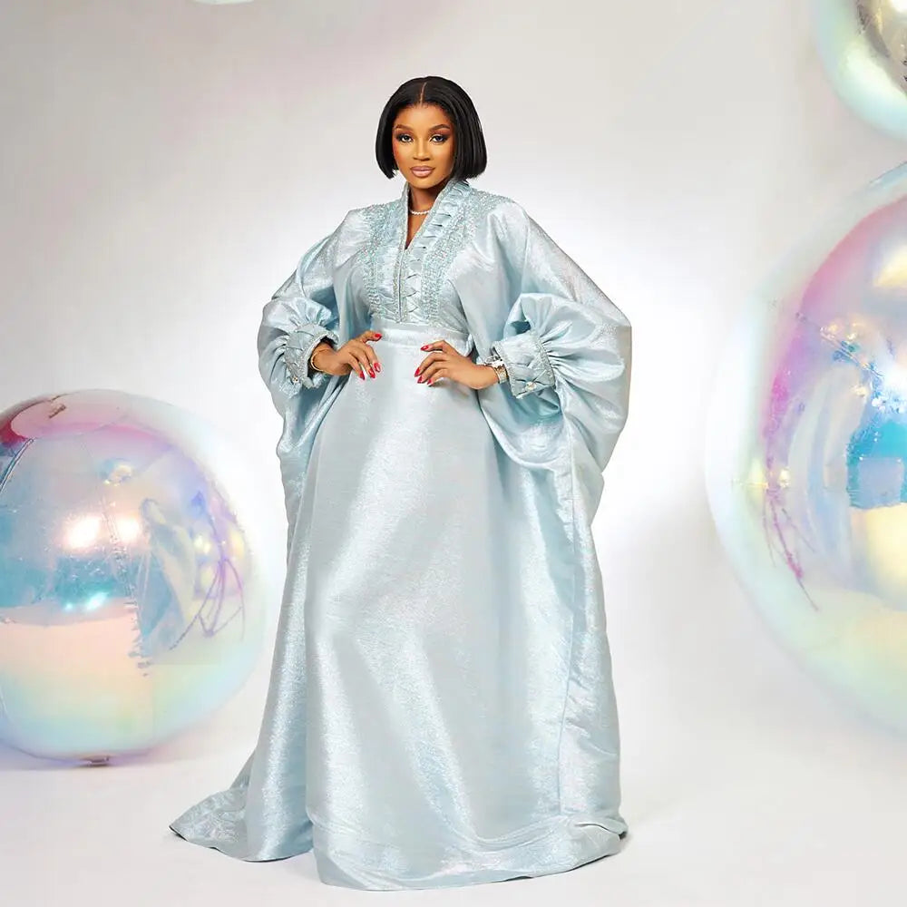 Rear view of a luxurious V-neck turkey dress for women, highlighting its sophisticated elegance and traditional African influences suitable for festive occasions.