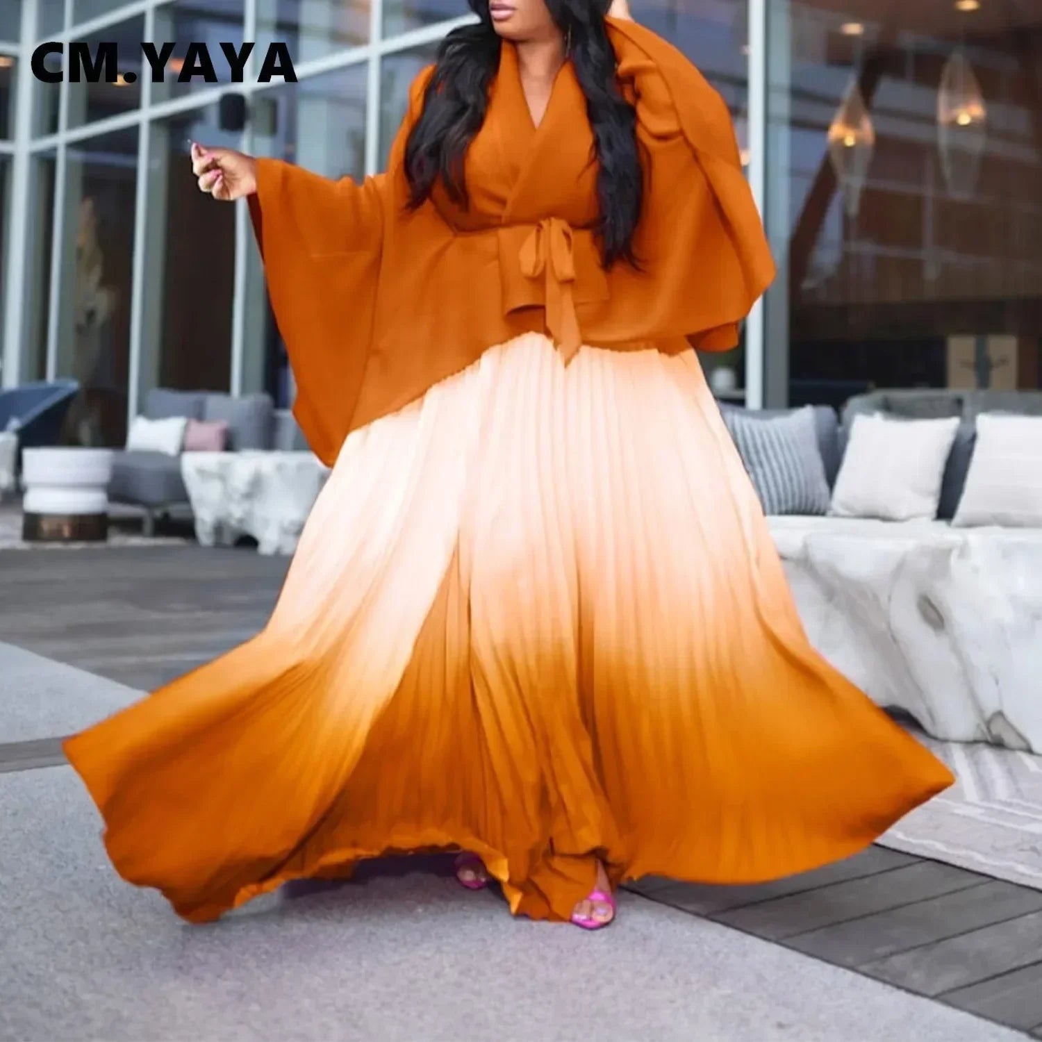 Elegant CM.YAYA two-piece outfit showcasing a stylish V-neck blouse with batwing sleeves and a sophisticated long pleated skirt, ideal for classy events.