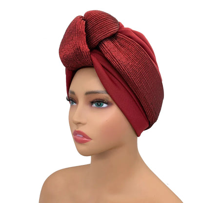 Close-up view of a glitter knot turban cap for women, ideal for all occasions, showcasing intricate fabric texture in elegant style.