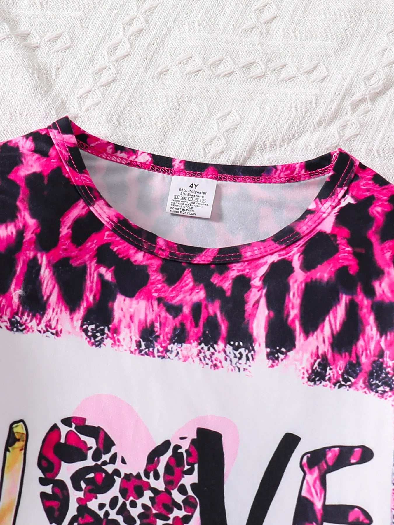 Chic close-up of the pink leopard print on a girls long sleeve top from the 2-piece set, designed for stylish comfort and effortless chic for children ages 4-6.