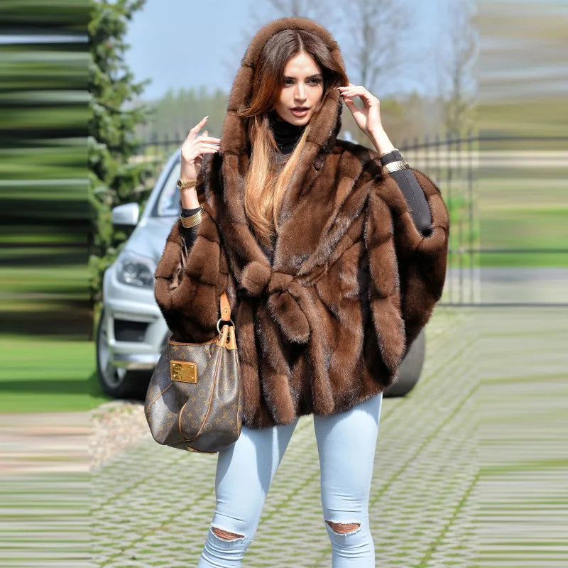 Elegant women's hooded faux fur coat styled with batwing sleeves, ideal for chic autumn and winter outfits.