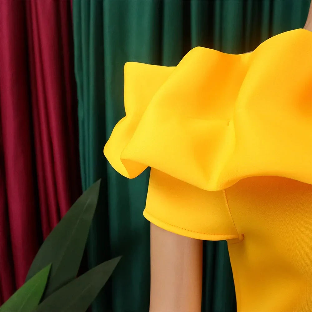 Close-up view of the luxurious fabric of an off-shoulder mermaid dress, highlighting its exquisite ruffle decoration and solid colour.