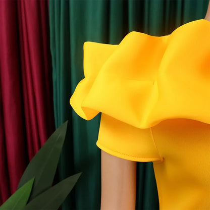 Close-up view of the luxurious fabric of an off-shoulder mermaid dress, highlighting its exquisite ruffle decoration and solid colour.