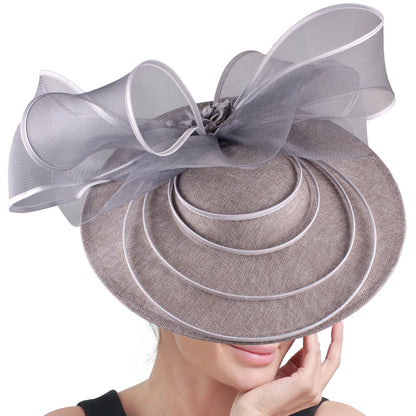 Elegant large fascinator hat for women, featuring exquisite floral decorations, perfect for enhancing a chic cocktail or church event look.