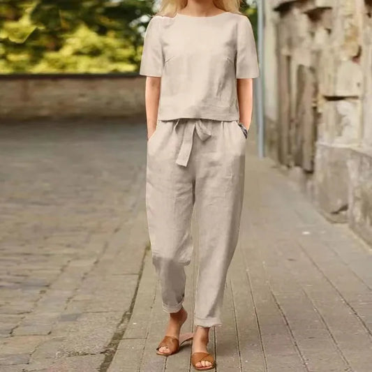 Elegant women's cotton linen tracksuit set in soft pastel hues, featuring a long sleeve pullover top and loose-fitting pants for a luxurious spring/summer outfit.