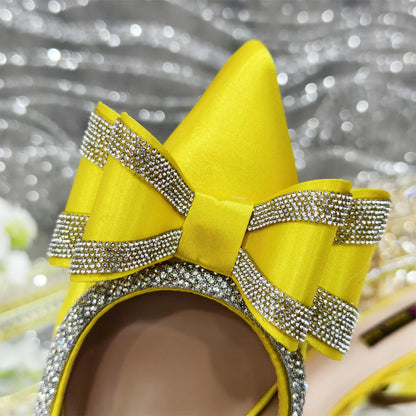 Close-up of luxurious butterfly-knot detail on women's low heel pumps, showcasing craftsmanship and elegant fashion for women's evening attire.