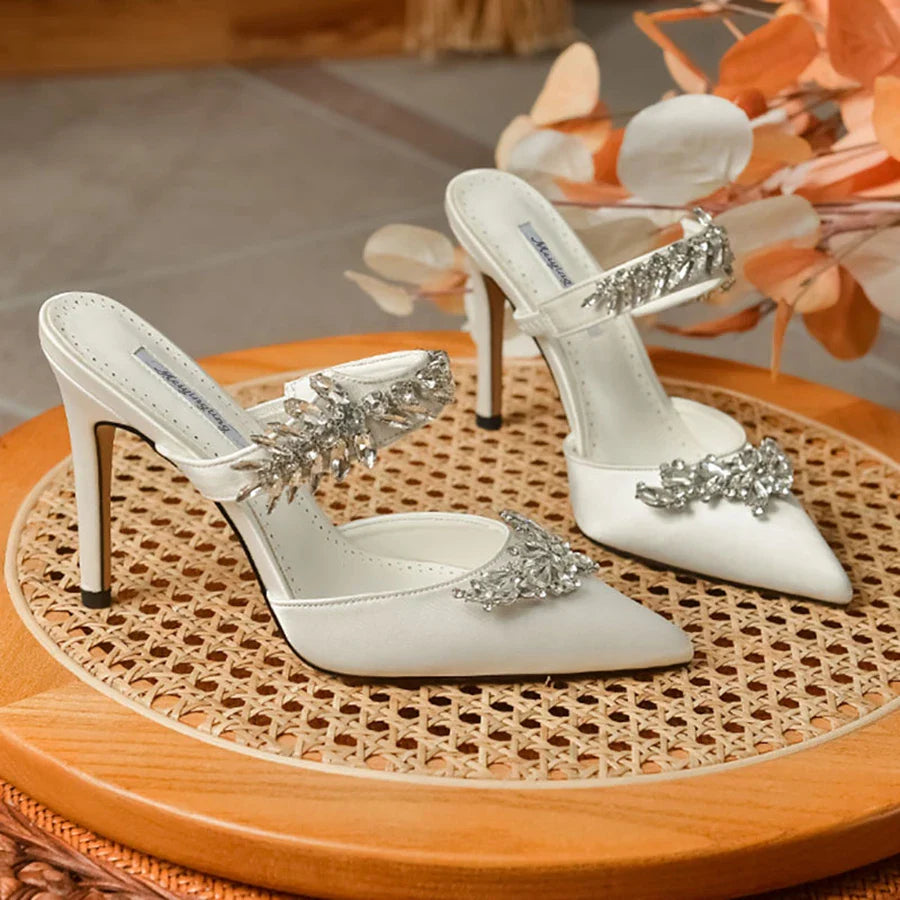 Stylish women's pointed stiletto mules made from luxurious silk, embellished with sparkling rhinestones, ideal for upscale summer outings.