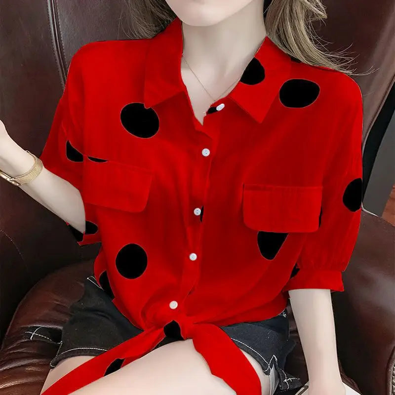 Model showcasing the stylish look of an oversized polka dot blouse with half sleeves and a fashionable bandage bow.