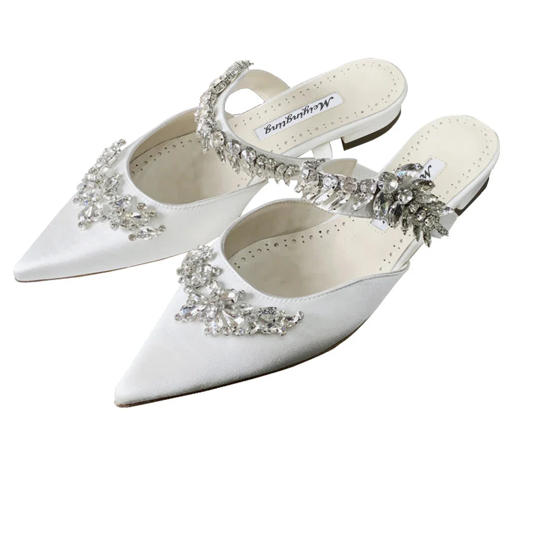 Luxury low heel mules sandals for women, combining comfort and style, with a silk upper and stunning crystal details for a glamorous summer look.