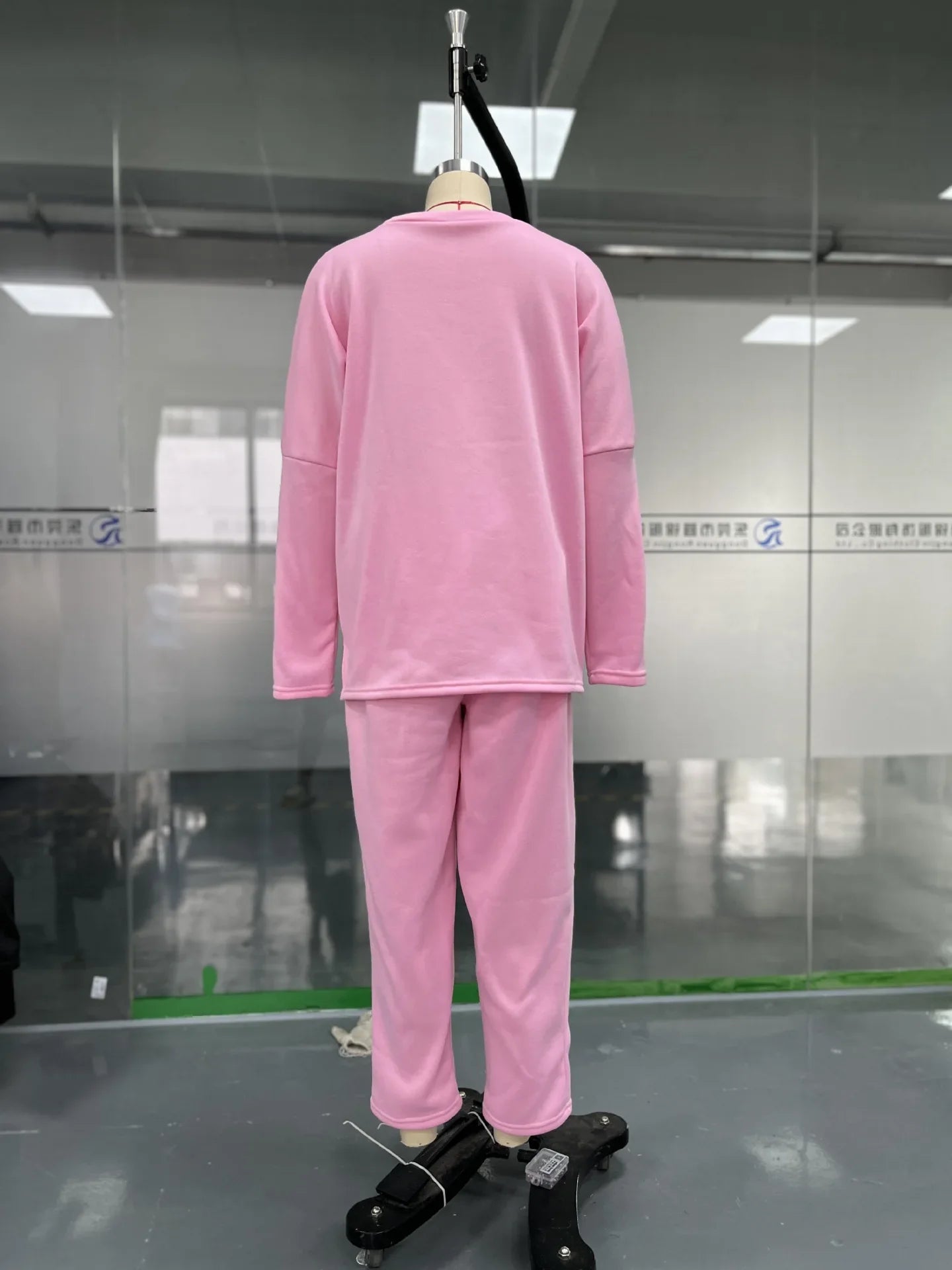 Elegant women's two piece set featuring a solid full sleeve O-neck top paired with stylish midi waist long pants adorned with functional pockets.