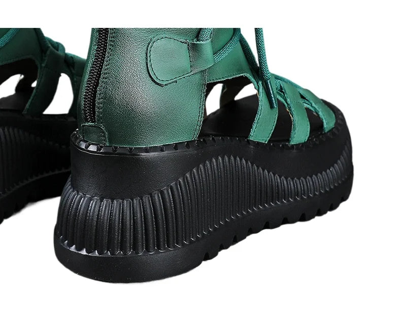 Elegant close-up detail of Koznoy's ethnic cow leather wedge ankle booties, featuring a stylish peep toe and sophisticated zipper closure.