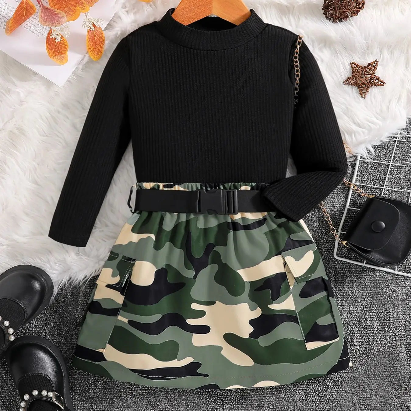 Stylish display of the 2-piece children's autumn fashion outfit showcasing a fashionable black top paired with a distinctive camouflage skirt.