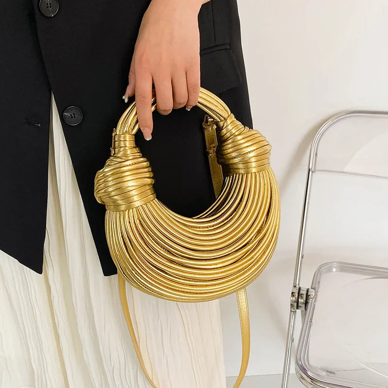 Stylish gold designer shoulder bag with a delicate flap shape, handcrafted for the modern woman.