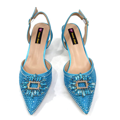 Matching handbag set with metal handle, crafted for women's style and elegance, complementing party shoes.