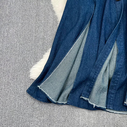 Mid-calf length sleeveless denim dress styled with a natural waistline, ideal for autumn and winter fashion.