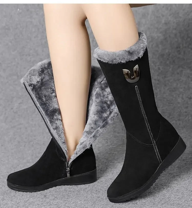 Chic black faux suede high fur boots designed for winter, showcasing a fashionable chunky heel and side zipper detail.