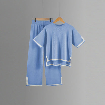 Elegant two-piece knitted trousers suit for women featuring wide-leg pants and short-sleeved pullover designed for luxury and comfort, perfect for spring and summer outfits.