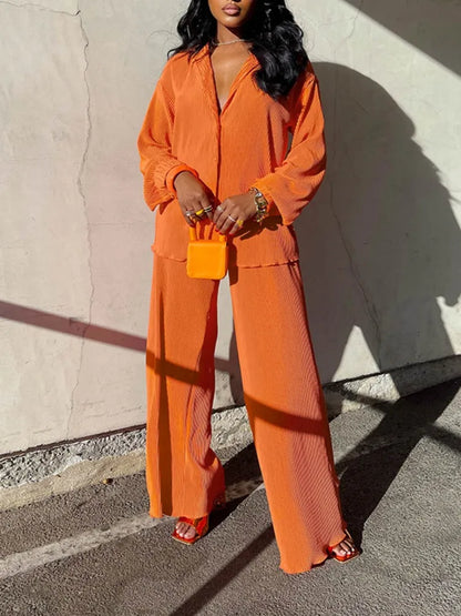 Stylish set comprising an oversized shirt and wide leg pants, ideal for seasonal layering in upscale fashion.