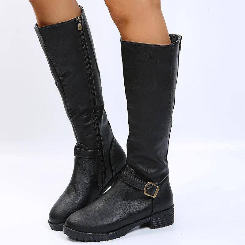 Fashionable women's PU leather knee-high boots with a modern square heel and attractive buckle detail, combining comfort and style for the ultimate winter footwear.