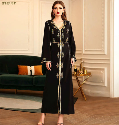 Close-up of sequined details on a golden velvet Moroccan Dubai dress, showcasing intricate craftsmanship and luxury.