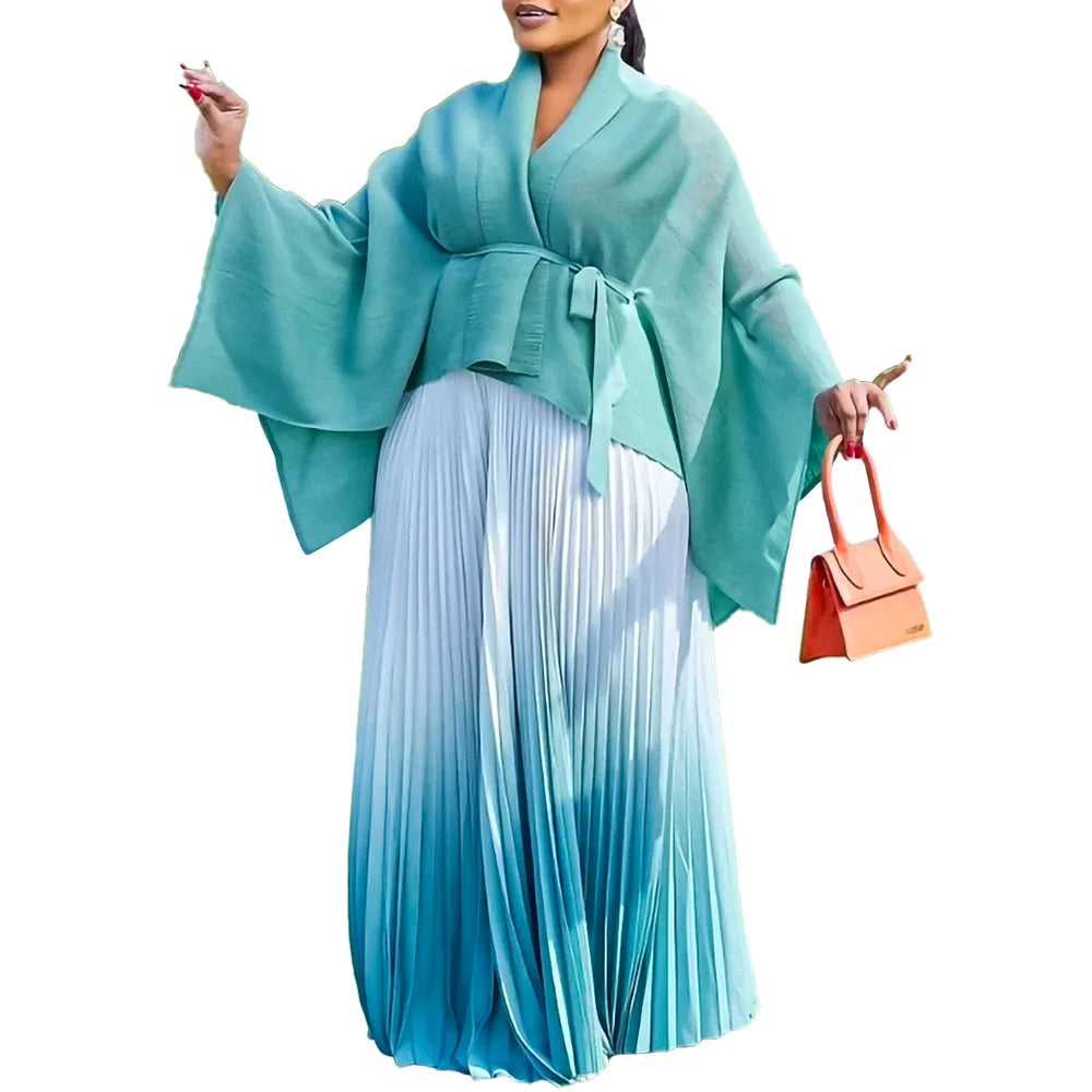 Luxury Dashiki two-piece outfit for women featuring a long sleeve V-neck top and a matching skirt, adorned in vibrant purple and blue patterns, perfect for cultural celebrations.