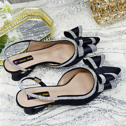 Close-up view of women's elegant high-heeled sandals featuring a sparkling crystal chain, ideal for upscale events and parties.