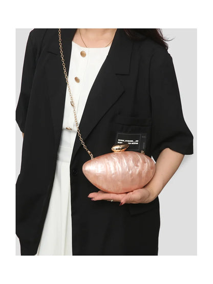 Luxurious acrylic evening bag in trendy ellipse shape, perfect for weddings and parties.