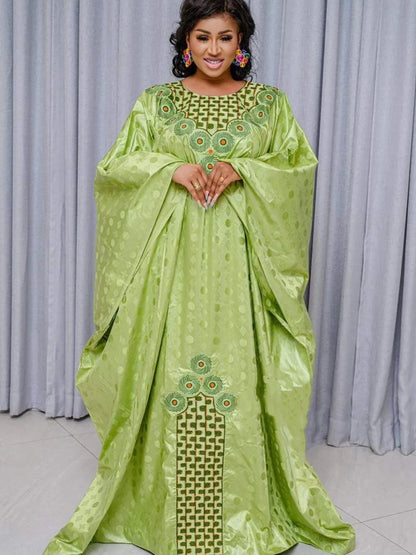 Elegant Traditional African Dashiki Gown for women, showcasing intricate embroidery and vibrant green Ankara fabric, perfect for weddings and upscale parties.