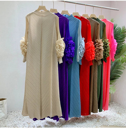 Close-up detail of the luxurious fabric and delicate folds of the women's elegant pleated maxi dress.