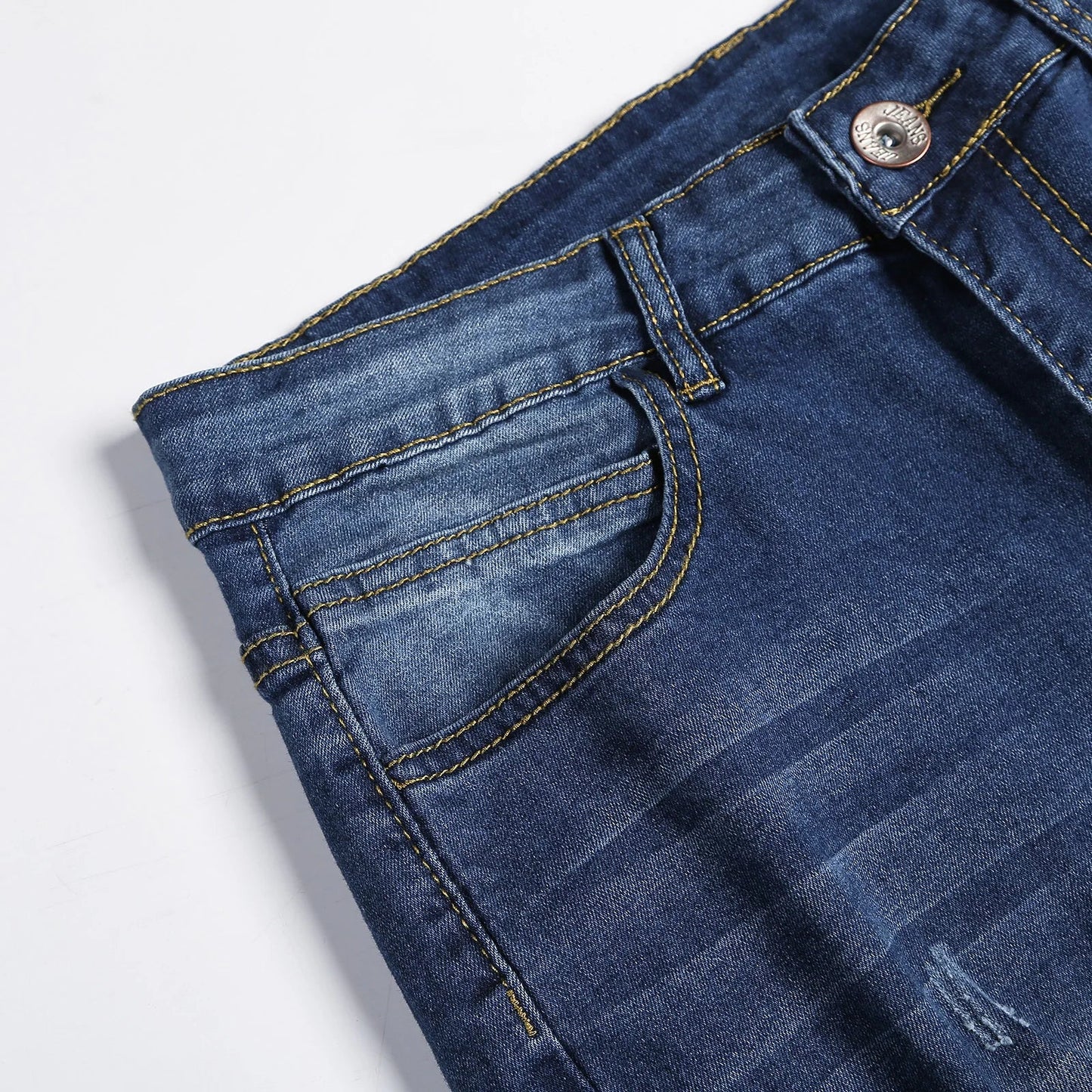 Elegant men's fashion with distressed details on premium skinny jeans, crafted from high-quality stonewashed denim for a trendy casual look.