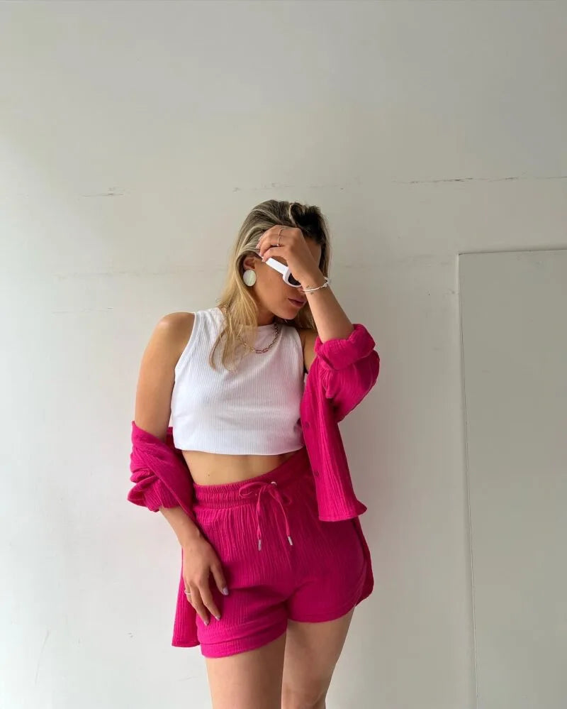 A model showcasing the elegant women’s grass green loose cardigan blouse paired with stylish drawstring shorts.