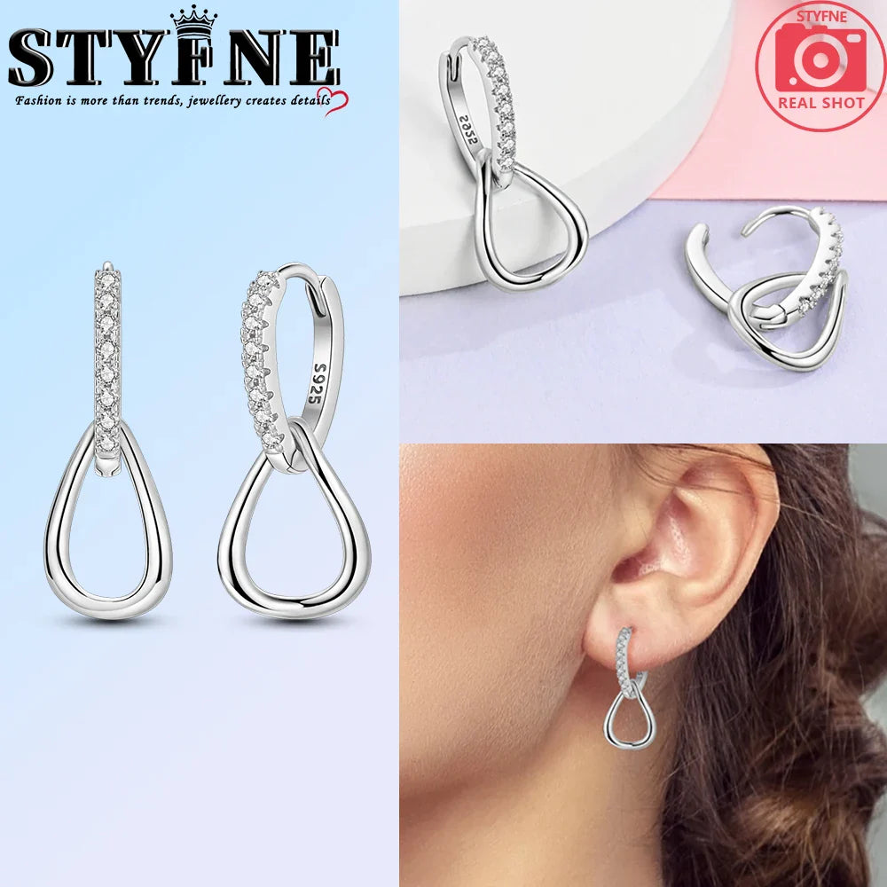 Close-up view of luxurious 925 sterling silver geometric earrings embellished with sparkling pavé crystals, perfect for chic women's fashion.