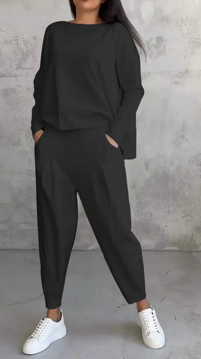 Full view of the elegant women's two piece outfit, combining a solid O-neck full sleeve top with ankle-length pants, epitomising modern luxury in fashion.