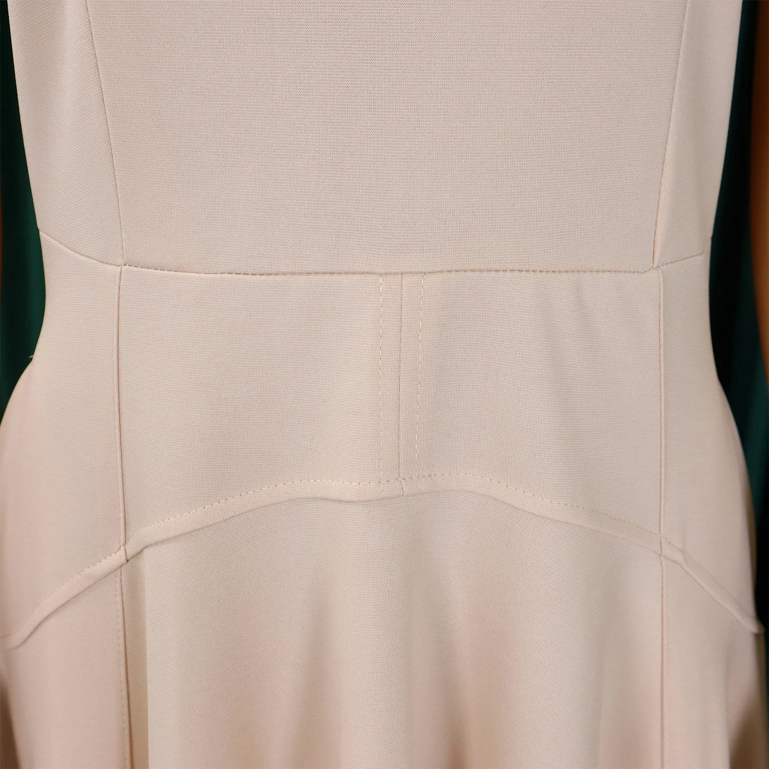 Back view of the stylish women's evening dress with a zipper closure, showcasing refined pleats and a tailored fit.