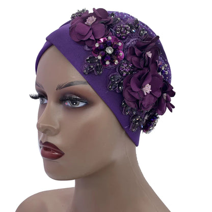 Chic African turban cap worn by a model, highlighting its luxurious design and flattering fit, ideal for all seasons.