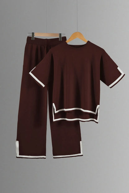 Close-up detail of the textured fabric of a sophisticated women's knitted trousers suit, crafted for comfort and style in every occasion.