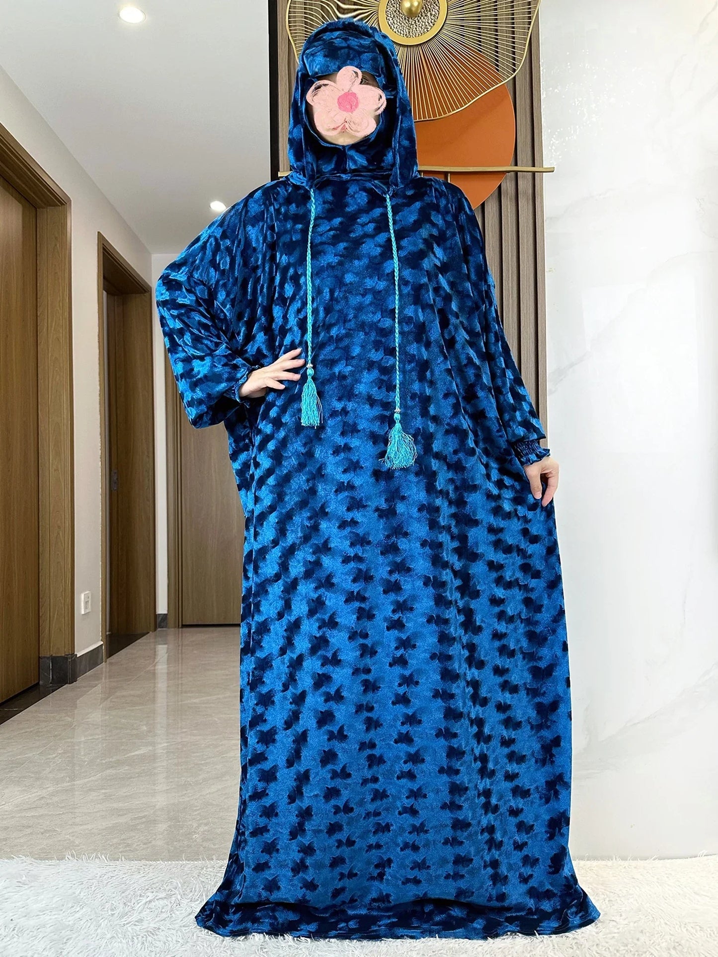 Model showcasing the luxury velvet Muslim Abaya with two hats, set against a minimalist background, representing an exquisite option for modern Islamic women's wear.
