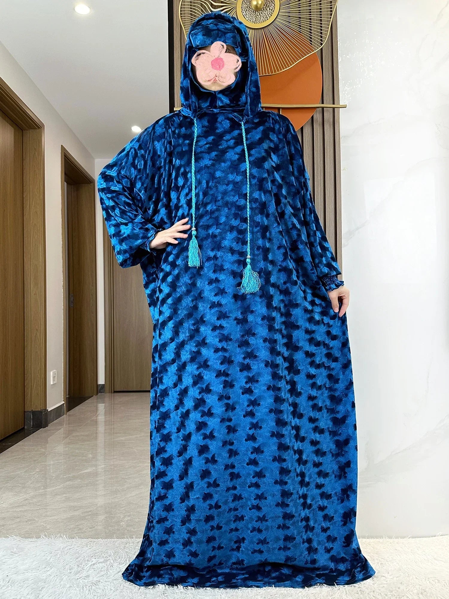Model showcasing the luxury velvet Muslim Abaya with two hats, set against a minimalist background, representing an exquisite option for modern Islamic women's wear.