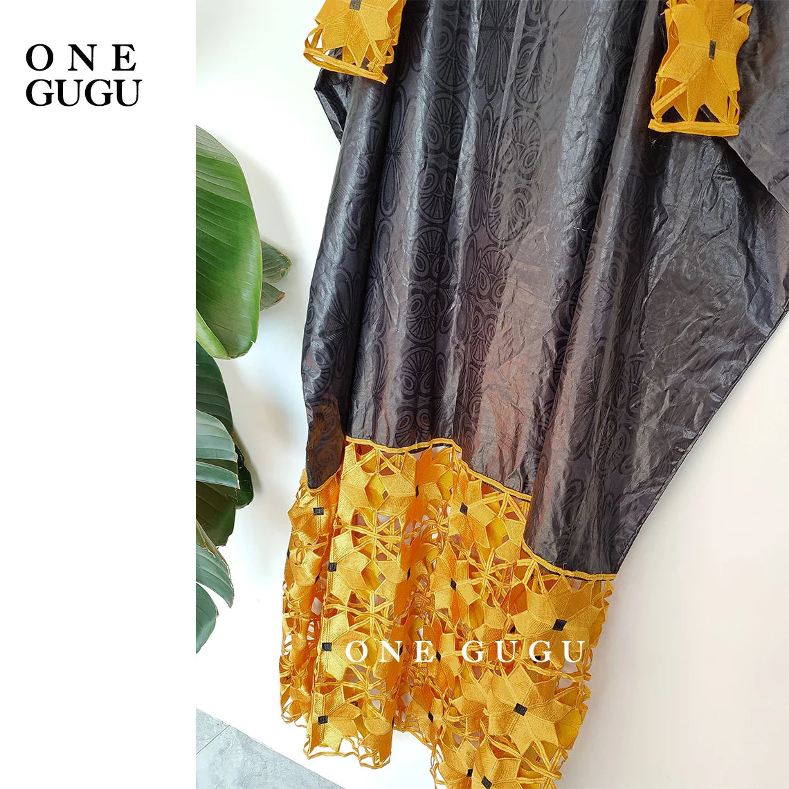 Model wearing luxurious gold and white African dress robe, highlighting its elegant design and comfortable fit for stylish women.