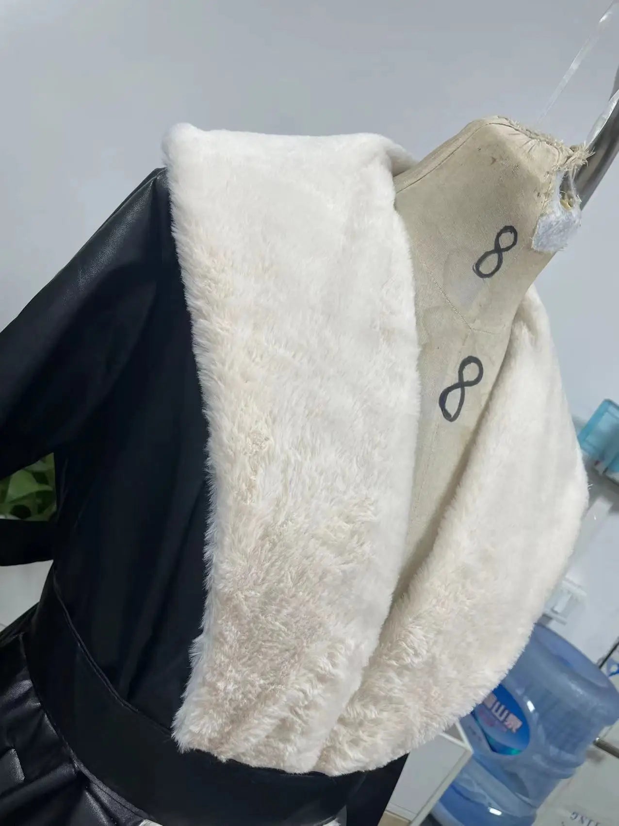 Close-up of premium faux leather material used in a sophisticated women's jacket.