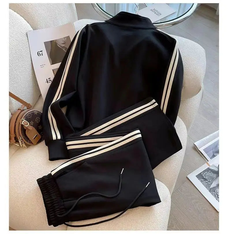 High-quality women's autumn winter outfit showcasing the latest trends with a two-piece sports set, including wide leg pants and a sophisticated embroidered coat.