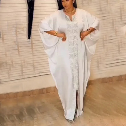 Elegant plus size African woman wearing a luxurious bat sleeve V-neck maxi dress with sparkling diamond details, styled as a traditional Muslim abaya.
